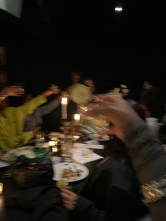 a group of people sitting around a dinner table