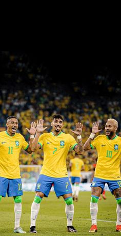 the soccer players are celebrating with their hands in the air