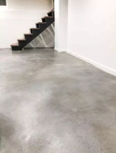 an empty room with stairs leading up to the second floor