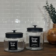 two glass jars sitting on top of a wooden table