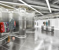 an empty clothing store with clothes hanging on racks