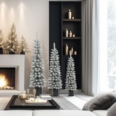 a living room filled with white christmas trees