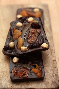 two pieces of chocolate with nuts on top