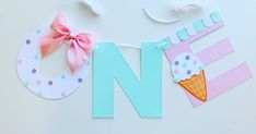 the letter n is made out of paper and decorated with ice cream cones, polka dots, and a pink bow