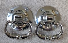 two chrome door handles on carpeted floor