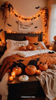 a bedroom decorated for halloween with pumpkins and candles