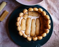 a cake with marshmallows and icing on a plate next to a bowl