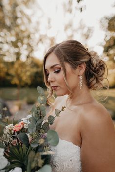 a woman in a wedding dress holding a bouquet