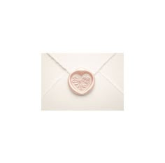 an envelope with a wax stamp on it and a heart in the middle that says love