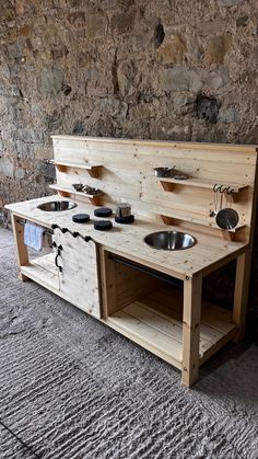 an outdoor kitchen made out of pallets and wood with two sinks on each side