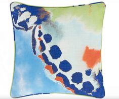 a blue and green pillow with an abstract design