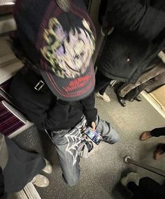 a person standing on a train with their feet up