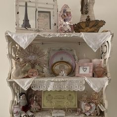 an antique china cabinet with many items on it