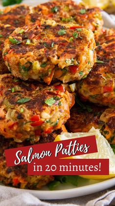 salmon patties on a plate with lemon wedges