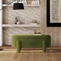 a green bench sitting in front of a book shelf