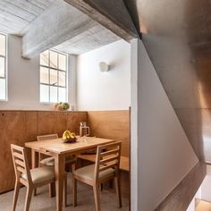 a wooden table and chairs in a room