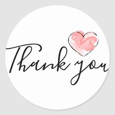 a thank sticker with the words thank and a heart in black ink on a white background