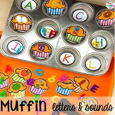 a muffin tin with letters and sounds on it