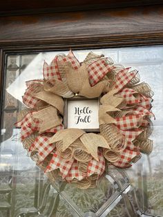 a red and white checkered burlock wreath with the words hello july on it