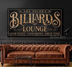 the hudson's hideout lounge sign is displayed in front of a couch and coffee table