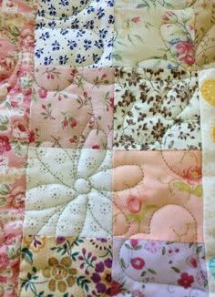 a patchwork quilt with flowers on it