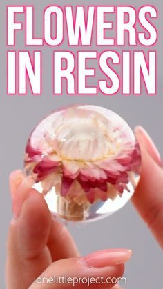 a person holding a glass ball with flowers in it and text overlay that reads, how to make flower vases in resin