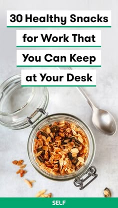 a glass jar filled with granola next to a spoon