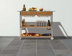 a table with some food on it in the middle of a flooring area,