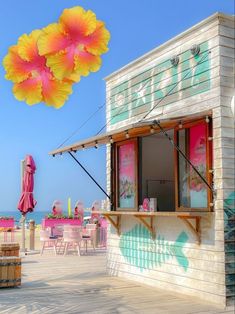 an image of a restaurant on the beach with umbrellas in the air above it