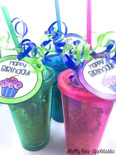 three plastic cups with straws in them and happy birthday tags attached to the lids