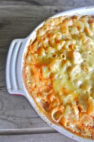 a casserole dish with macaroni and cheese in it on a wooden table