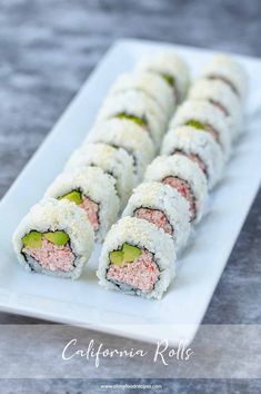 some sushi rolls on a white plate with cucumber