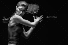 black and white photo of a woman holding a tennis racket - stock photo - images