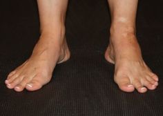 a person with bare feet standing on a mat