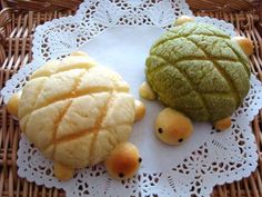 two pieces of fruit sitting on top of a doily next to each other in the shape of turtles