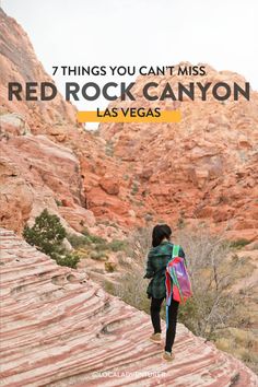 a woman with a backpack walking up the side of a mountain in red rock canyon, las vegas