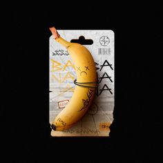 a yellow banana with writing on it sitting in a card holder against a black background