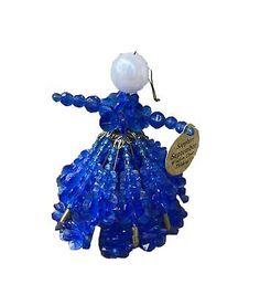 a blue glass figurine with a white ball hanging from it's neck