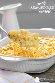 macaroni and cheese casserole in a white dish with a serving spoon