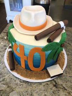 a cake that has the number 40 on it and is decorated with an image of a man's hat