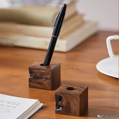 a pen sitting on top of a wooden block