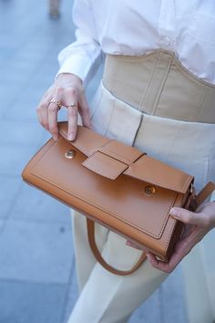 Add a touch of warmth and sophistication to your ensemble with the "Caramel Rectangular Bag" from Lunarity Garage. This chic and stylish accessory features a sleek rectangular design in a rich caramel color, making it a versatile addition to your wardrobe. The caramel hue exudes a sense of timeless elegance and pairs beautifully with a variety of outfits. Crafted with meticulous attention to detail, this bag offers both fashion and functionality. The compact size is perfect for carrying your ess Brown Satchel Baguette Bag For Office, Trendy Brown Office Box Bag, Trendy Brown Box Bag For Office, Trendy Brown Baguette Bag For Office, Trendy Brown Office Flap Bag, Versatile Brown Box Shoulder Bag, Versatile Light Brown Rectangular Shoulder Bag, Versatile Brown Shoulder Box Bag, Brown Baguette Bag With Adjustable Strap For Office