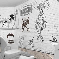 a white brick wall with barbershop signs and drawings on it, along with a chair in the foreground