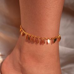 Step into the party with glamour and grace wearing our Gold Chacha Anklet - adorned with delicate leaves for a touch of natural elegance. This ankle bracelet isn't just a gift; it's a dazzling expression of style and sophistication, making it the perfect accessory to elevate her look with a gorgeous sparkle! #YOU MAY LIKE THIS Birthstone anklet https://www.etsy.com/listing/1545880373/birthstone-anklet-shiny-layered-chain dainty gold anklet https://www.etsy.com/listing/1699658668/dainty-gold-ankl Dangle Anklets For Parties, Rose Gold Anklets For Party, Gold Metal Wedding Anklet, Bohemian Gold Anklets For Party, Elegant Gold Chain Anklet, Elegant Gold Crystal Anklets, Gold Metal Chain Anklets, Ankle Bracelets Gold, Wedding Anklets