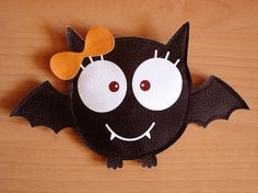 a bat shaped paper decoration on top of a wooden table