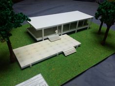 a model of a building with trees and grass