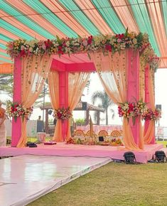 a man and woman standing in front of a stage set up for a wedding ceremony