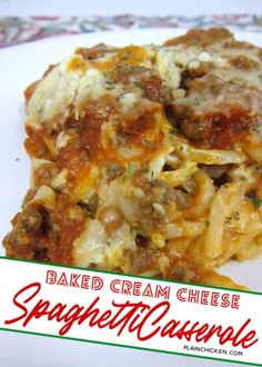 baked cream cheese spaghetti casserole on a white plate with red and green border