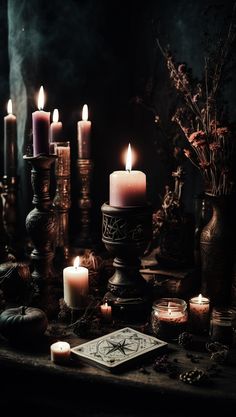 a table topped with lots of lit candles