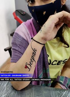 a woman with a tattoo on her arm wearing a face mask